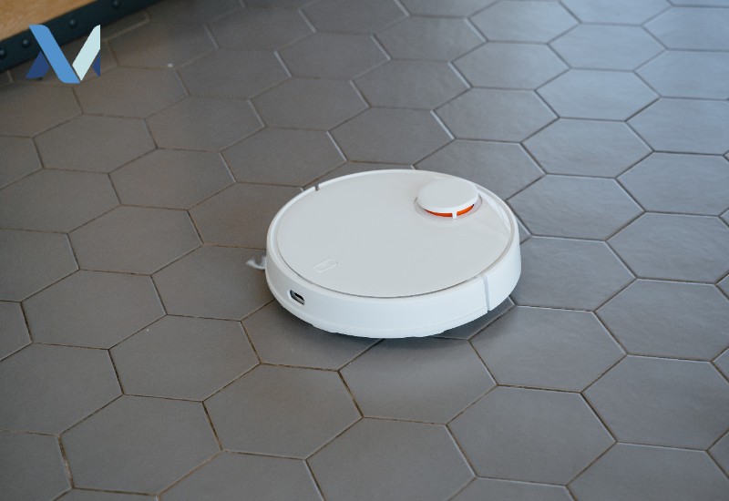 Robot vacuum cleaning a tiled floor